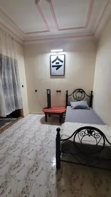 a bedroom with a bed and a red bench at Comfortable room, balcony in Marrakech