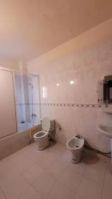 a bathroom with two toilets and a sink and a tub at Comfortable room, balcony in Marrakech