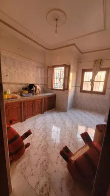 a large kitchen with two chairs and a table at Comfortable room, balcony in Marrakech