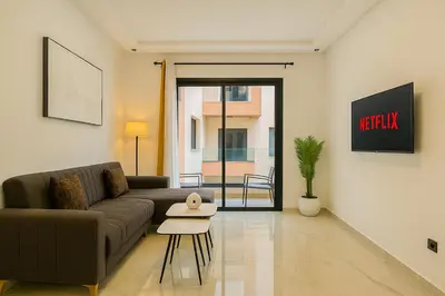 a living room with a couch and a table at Laube Hivernage in Marrakech