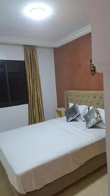 a bedroom with a bed with two pillows on it at Appartement Majorella Gueliz Centre Marrakech in Marrakech