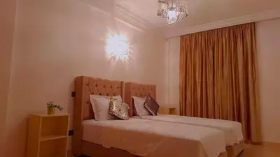 a bedroom with a bed and a chandelier at Appartement Majorella Gueliz Centre Marrakech in Marrakech