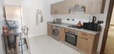 a small kitchen with a stove and a microwave at Ochre City apartment Balcony, Pool, Fiber Optic, Free Parking - Family ONLY in Marrakech