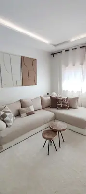 a white living room with a couch and a table at Ochre City apartment Balcony, Pool, Fiber Optic, Free Parking - Family ONLY in Marrakech
