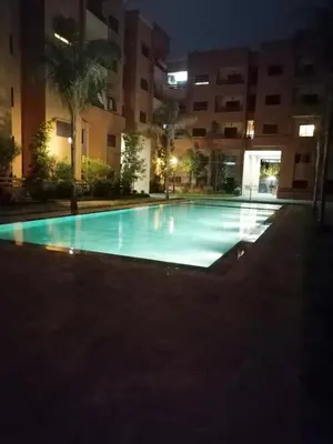 an empty swimming pool at night in a building at Ochre City apartment Balcony, Pool, Fiber Optic, Free Parking - Family ONLY in Marrakech