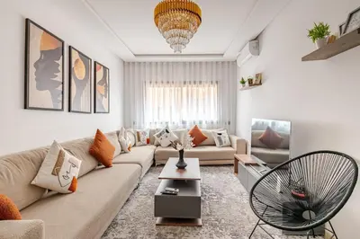 a living room with a couch and a table at Urban Comfort - Pool - Netflix IPTV Parking in Marrakech