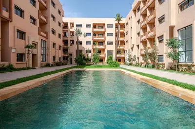 a swimming pool in the middle of a building at Urban Comfort - Pool - Netflix IPTV Parking in Marrakech