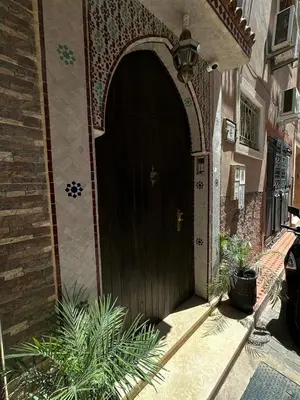 an entrance to a house with a wooden door at Riad apartment Beldi style in Marrakech