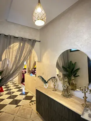 a room with a mirror and a checkered floor at Riad apartment Beldi style in Marrakech