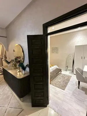 a room with a bed and a large mirror at Riad apartment Beldi style in Marrakech