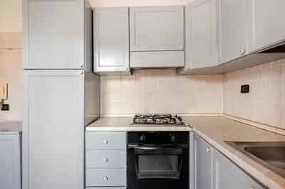 a kitchen with white cabinets and a stove top oven at Modern Elegance & Moroccan Charm - Gueliz Center in Marrakech