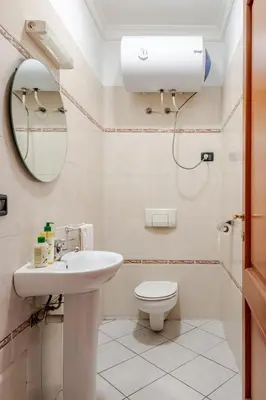 a bathroom with a toilet and a sink and a mirror at Modern Elegance & Moroccan Charm - Gueliz Center in Marrakech