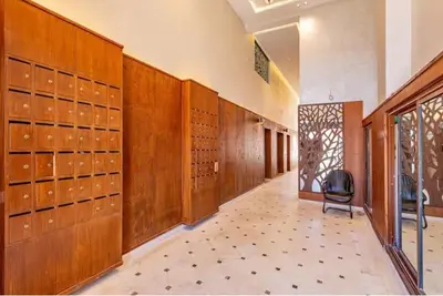 a large room with wooden lockers in a dressing room at Élégant et confortable, près de l'aéroport et de la gare in Marrakech
