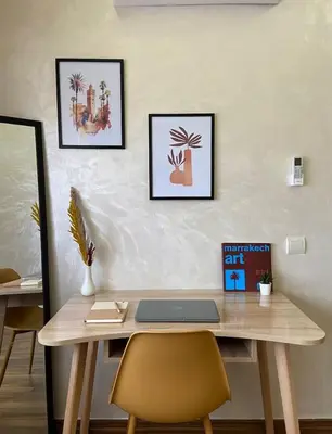 a wooden desk with a laptop on top of it at Élégant et confortable, près de l'aéroport et de la gare in Marrakech
