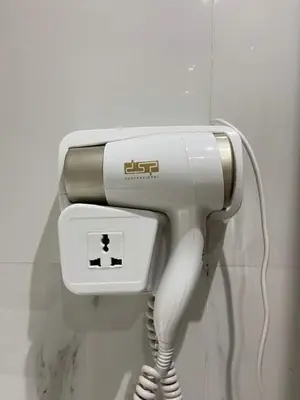 a landline phone is attached to a wall at Élégant et confortable, près de l'aéroport et de la gare in Marrakech