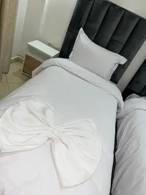 a white bed with a bow on top of it at Appartement de luxe 15 mn du centre in Marrakech