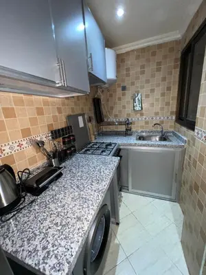 a kitchen with a sink and a stove at Appartement de luxe 15 mn du centre in Marrakech