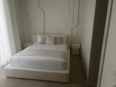 a bedroom with a white bed with white sheets and pillows at Villa Zeytoune sans vis à vis in Marrakech