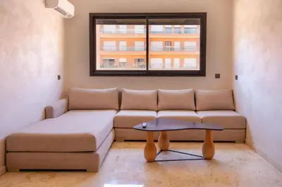 a living room with a couch and a table at Heart of Marrakech - Hivernage 2 bedroom apartment in Marrakech