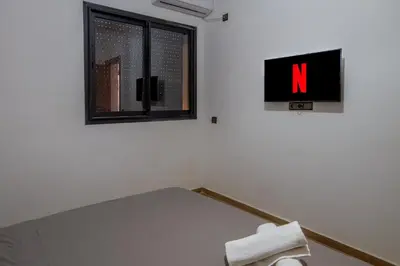 a room with a sign on the wall and a window at Heart of Marrakech - Hivernage 2 bedroom apartment in Marrakech