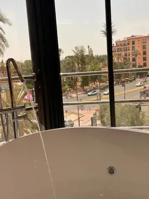 a bath tub with a view of a street at Central nest romantic stay in Marrakech