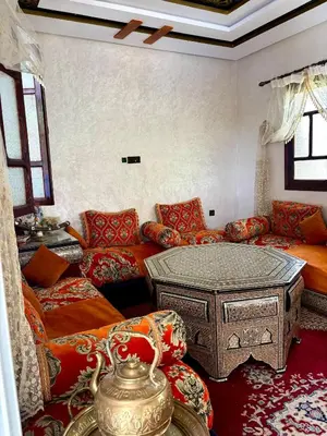 a living room with a couch and a table at luxery in Aït Bou Setta
