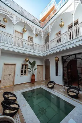 a large room with a swimming pool in a building at Riad Le Terracotta in Marrakech