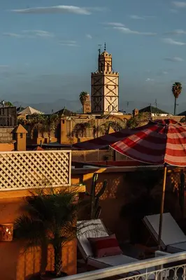 a view of a building with a clock tower and an umbrella at Riad Le Terracotta in Marrakech