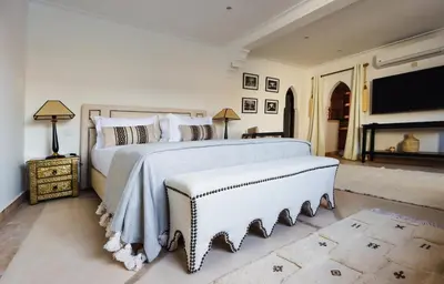 a bedroom with a large bed and a tv at Riad Madame Riad privé à deux pas de la Place Jemaa El Fna in Marrakech