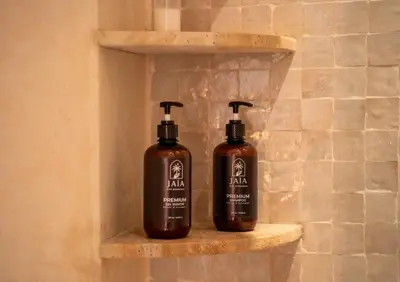 two bottles of soap on a shelf in a bathroom at Riad JAIA in Marrakech