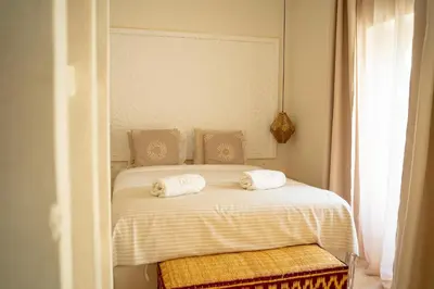 a white bed with two pillows on top of it at Riad JAIA in Marrakech