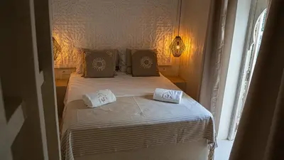 a bedroom with a bed with two pillows on it at Riad JAIA in Marrakech