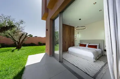 a bedroom with a bed and a large window at Villa Dar Al Jaddah, Luxury and Refinement in Marrakech