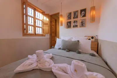 a bedroom with a bed with towels on it at Riad Jardin d'Orient in Marrakech