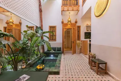 a hallway with a pool in the middle of a house at Riad Jardin d'Orient in Marrakech