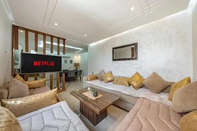 a living room with a couch and a table at Urban Dream piscine et central in Marrakech