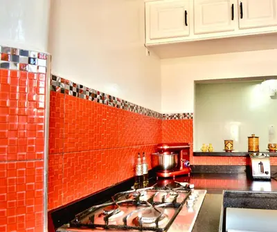 a kitchen with red brick walls and a stove at DarKech luxury and comfort in Marrakech