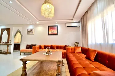 a living room with a couch and a table at DarKech luxury and comfort in Marrakech