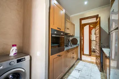 a kitchen with a washer and a washing machine at La Palmeraie 2BR Garden & Pool in Marrakech