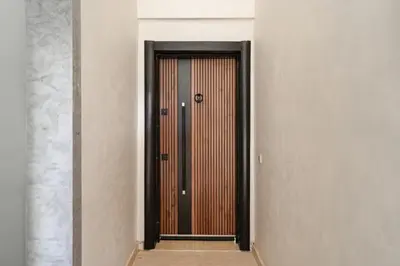 a wooden door in a room with a wall at Marrakech Duplex Spacieux avec Terrasse in Marrakech