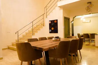 a dining room with a wooden table and chairs at duplex a Gueliz in Marrakech