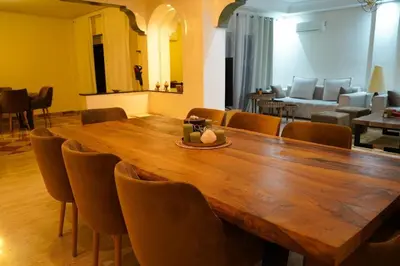 a large wooden table and chairs in a room at duplex a Gueliz in Marrakech
