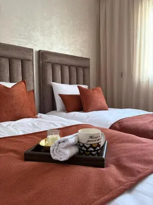 a tray with a cup of coffee on a bed at Appartement refait à neuf in Marrakech