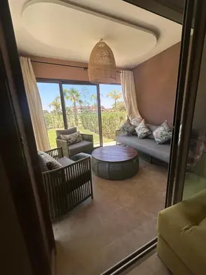 a living room with a couch and a table at Relax appartement in Marrakech