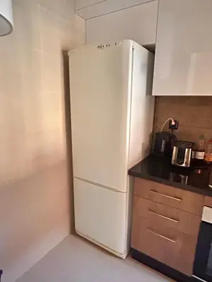 a kitchen with a white refrigerator in the corner at Relax appartement in Marrakech