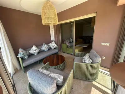 a living room with couches and chairs and a table at Relax appartement in Marrakech