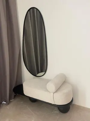 a chair with a mirror on a wall at Villa les palmiers in Marrakech