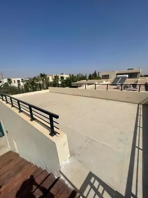 a bench sitting on the side of a roof at Villa les palmiers in Marrakech