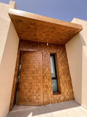 a building with a wooden door and a window at Villa les palmiers in Marrakech