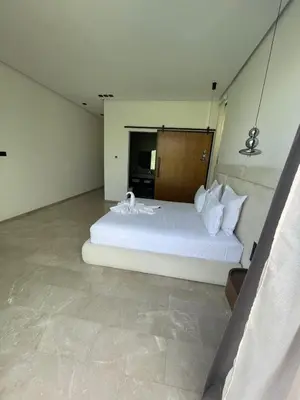 a bedroom with a large white bed in a room at Villa les palmiers in Marrakech